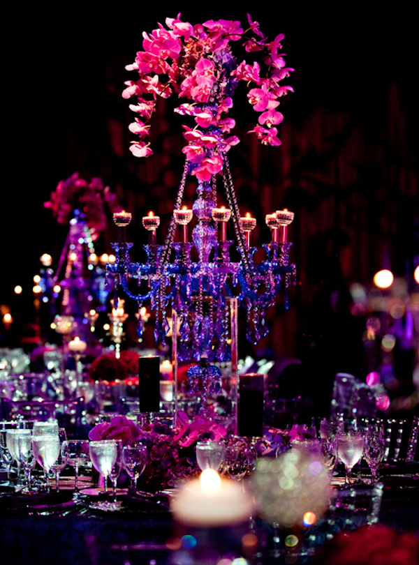 pink orchid centerpiece with electric blue candleabra - photo by Maloman Photographers